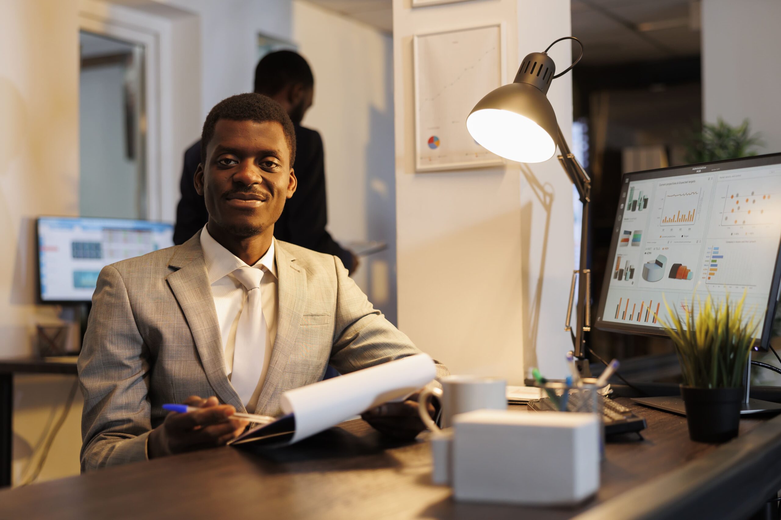 african-american-manager-holding-clipboard-analyzing-marketing-statistics-working-hours-company-strategy-startup-office-smiling-business-man-looking-papers-with-investment-graph